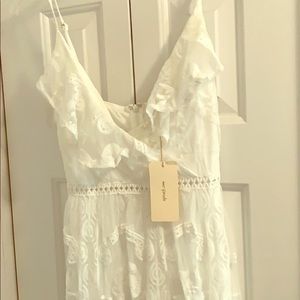 Long white sheer dress with lace print.